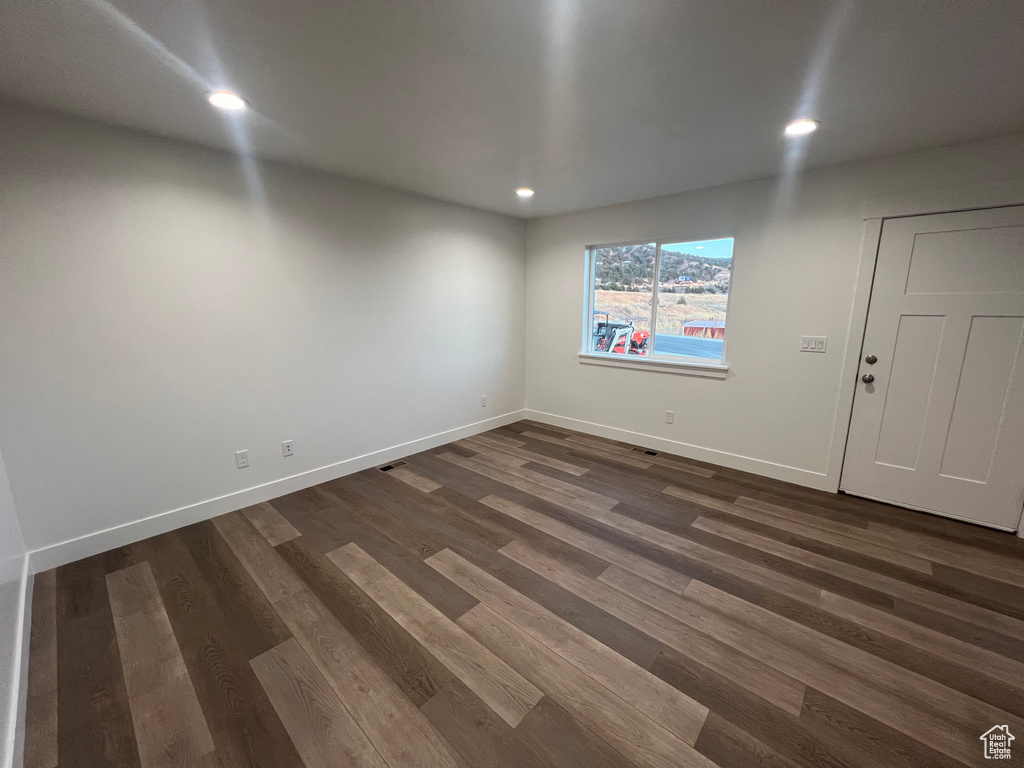 Unfurnished room featuring dark hardwood / wood-style flooring