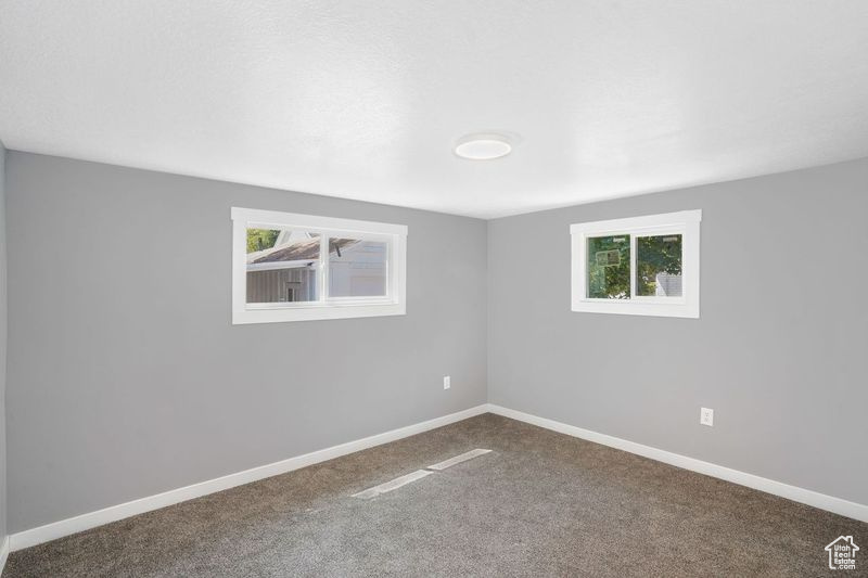 Spare room with carpet flooring and plenty of natural light