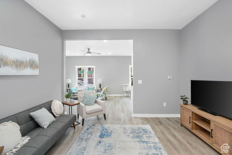 Living room featuring light hardwood / wood-style flooring and ceiling fan