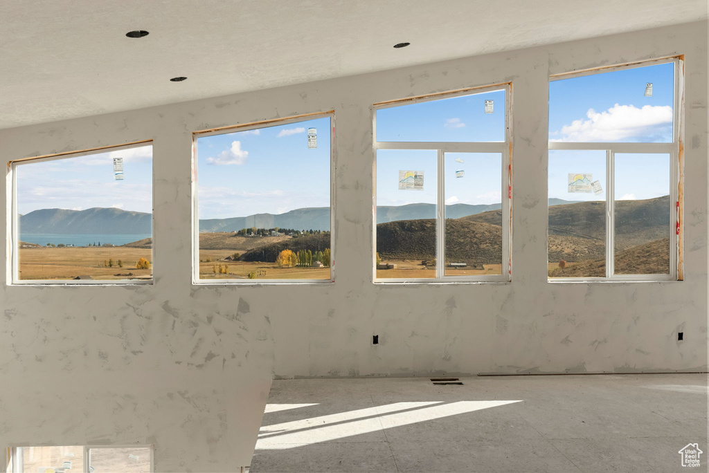 Spare room featuring a mountain view and a wealth of natural light