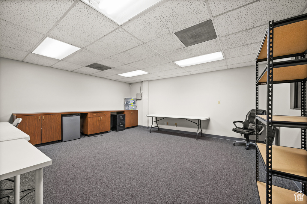 Exercise area featuring a drop ceiling and carpet flooring