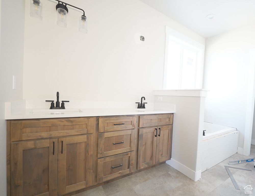 Bathroom featuring vanity and a bath