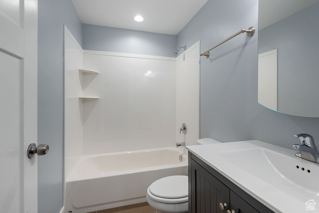 Full bathroom featuring toilet, shower / washtub combination, and vanity