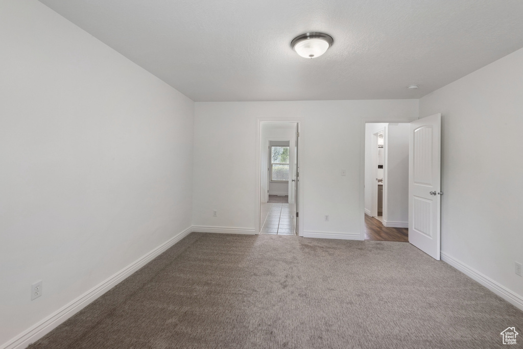 Unfurnished bedroom with carpet flooring