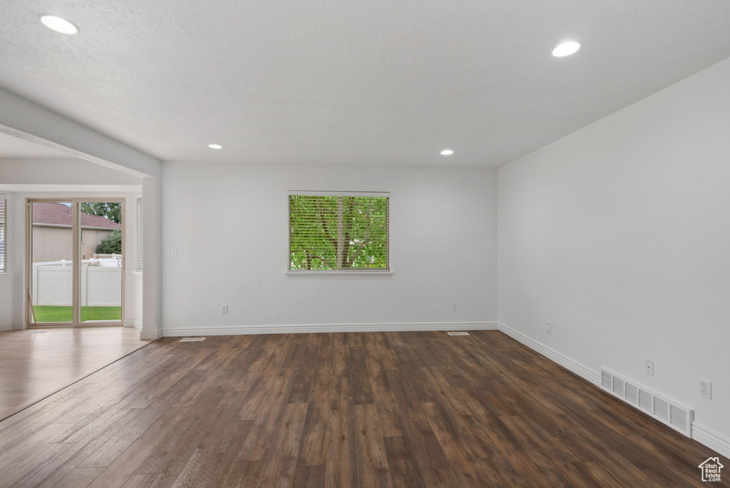 Spare room featuring wood-type flooring