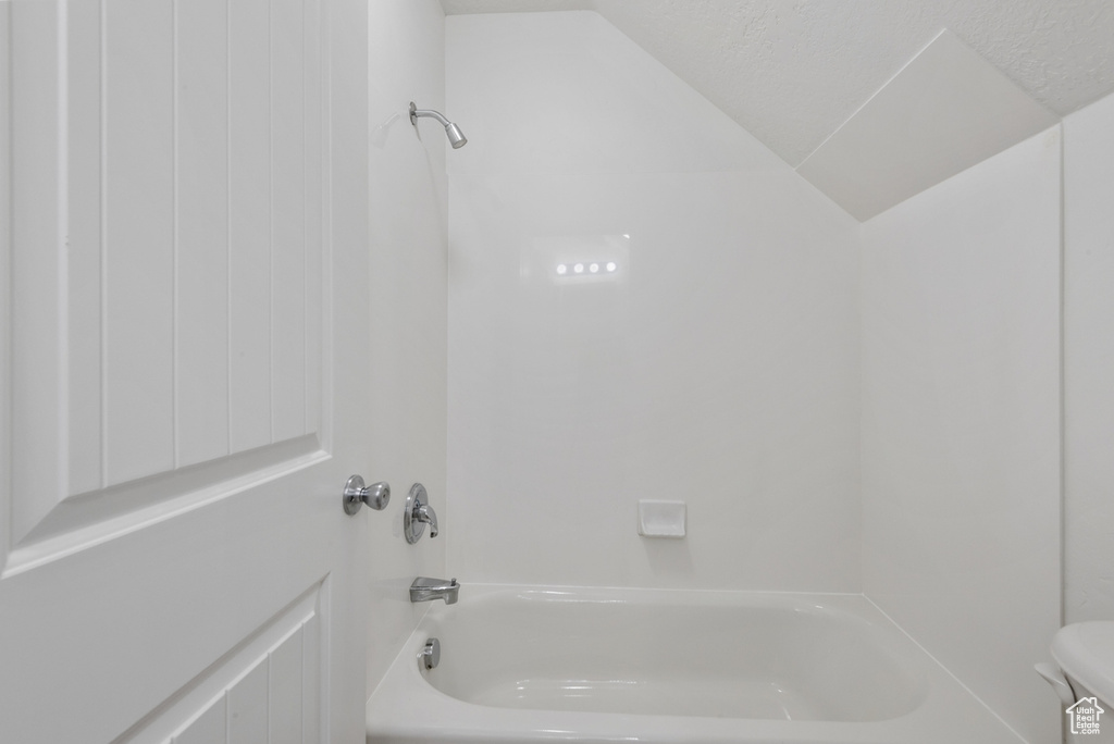 Bathroom featuring washtub / shower combination and toilet