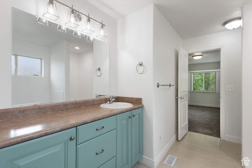 Bathroom with vanity and tile patterned flooring