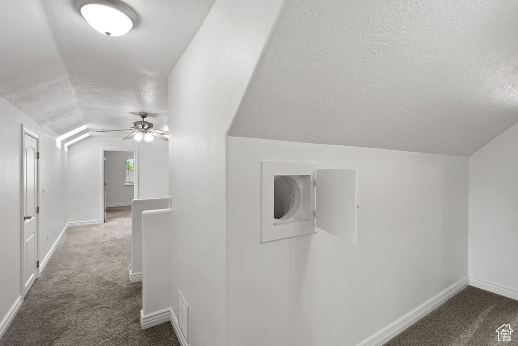 Bonus room featuring carpet floors, a textured ceiling, ceiling fan, and lofted ceiling