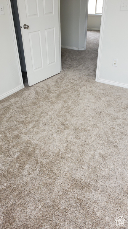 Unfurnished bedroom featuring carpet floors and baseboards