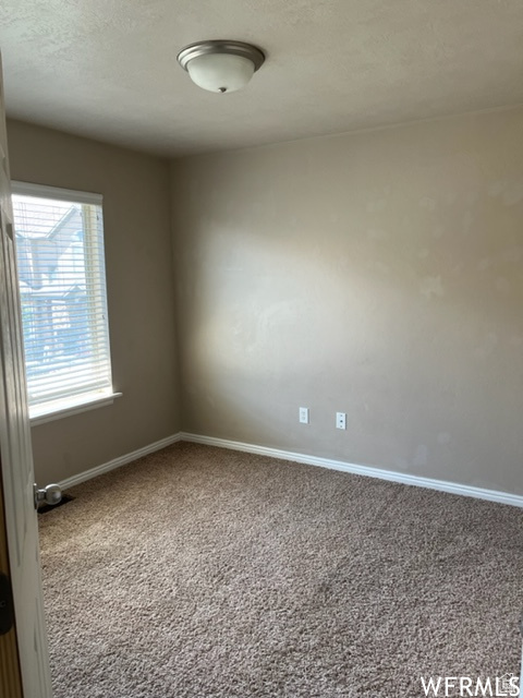 Empty room with carpet floors