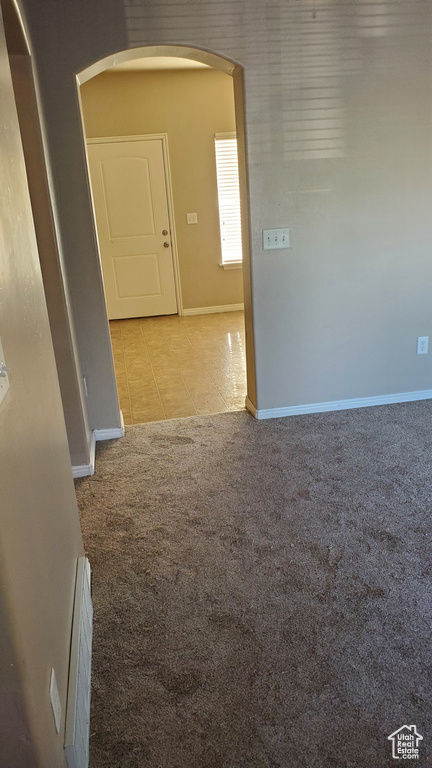 Empty room with light colored carpet