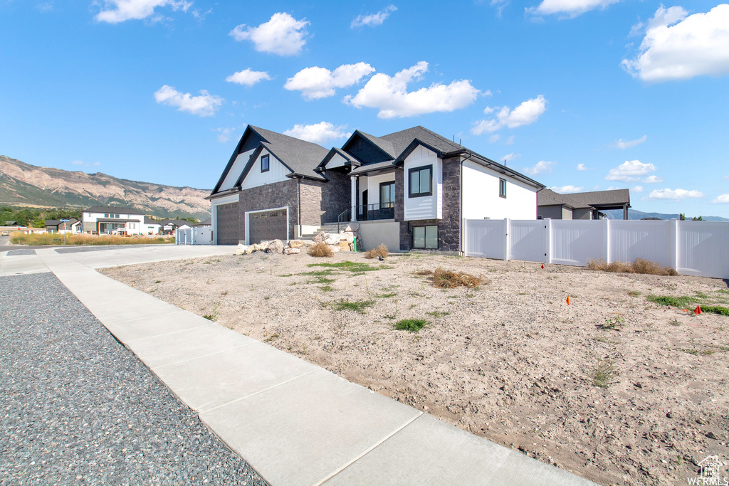 View of front of house featuring a mountain view and a garage