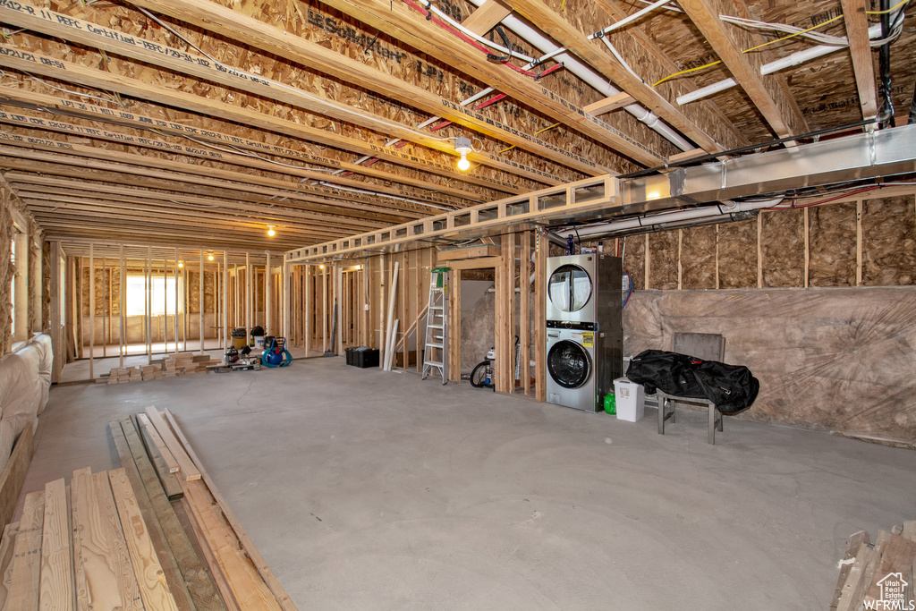 Basement with stacked washing maching and dryer