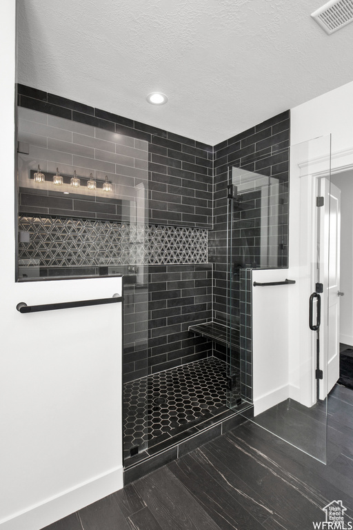 Bathroom with tile patterned flooring and an enclosed shower