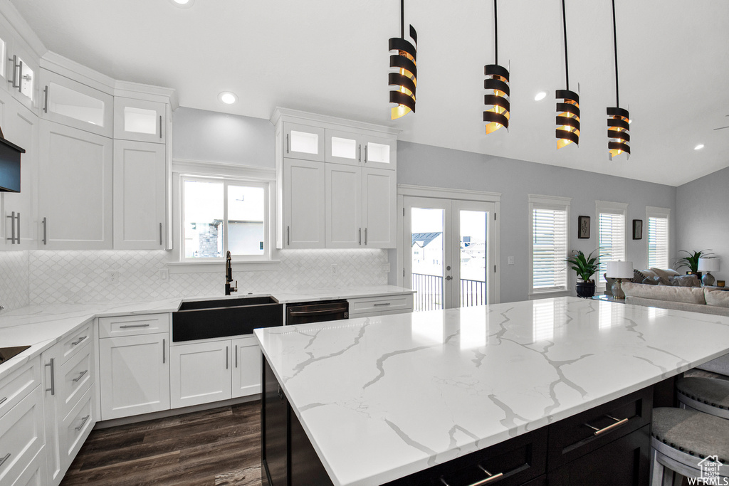 Kitchen featuring backsplash, a wealth of natural light, and sink