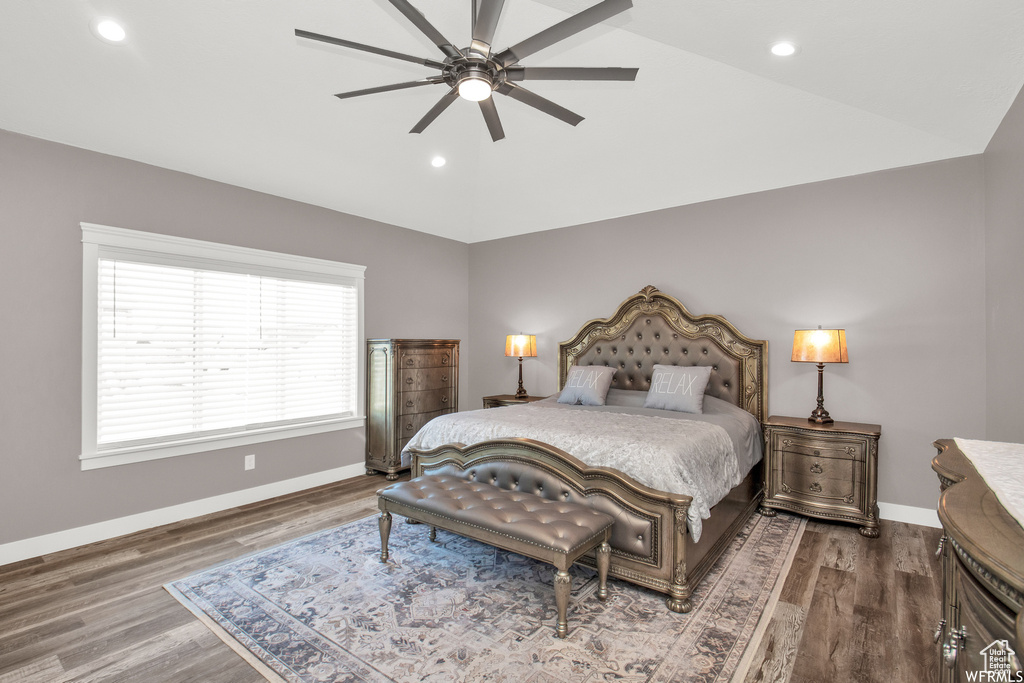 Bedroom with wood-type flooring, vaulted ceiling, and ceiling fan