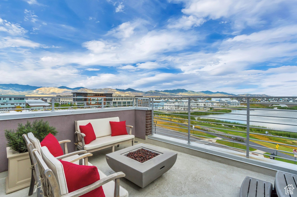 View of patio / terrace with a mountain view, a balcony, and an outdoor fire pit