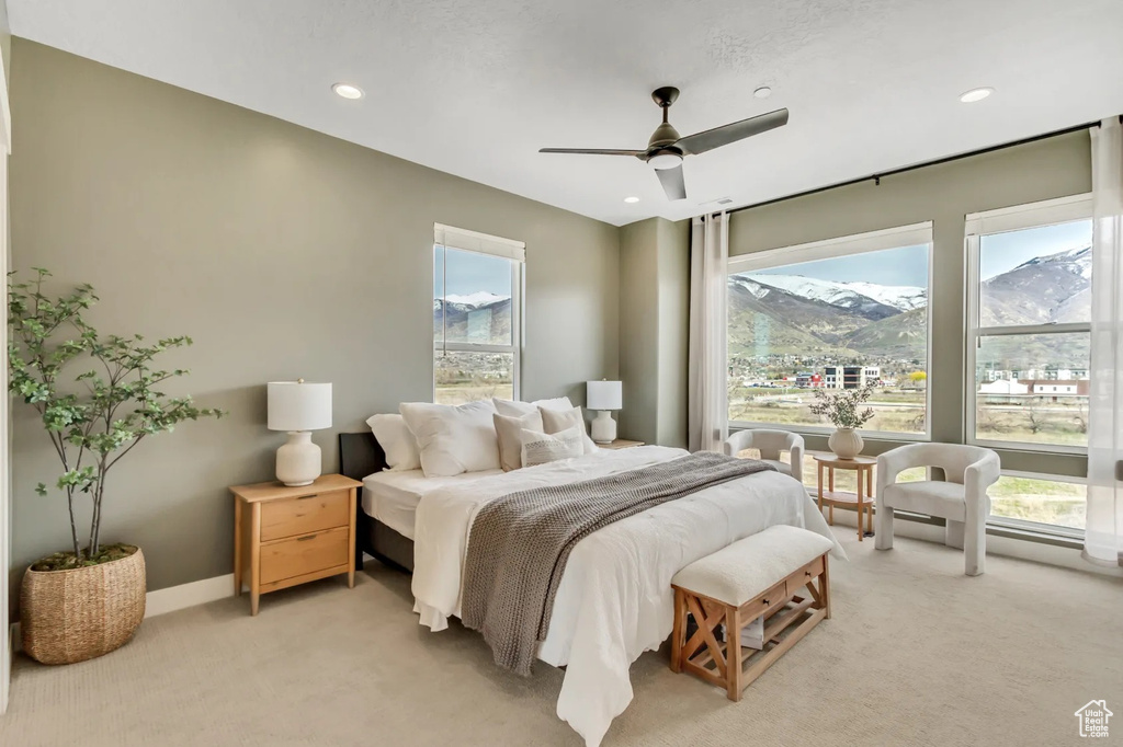 Bedroom with a mountain view, carpet flooring, and ceiling fan