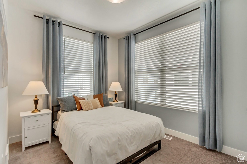 Bedroom with light carpet