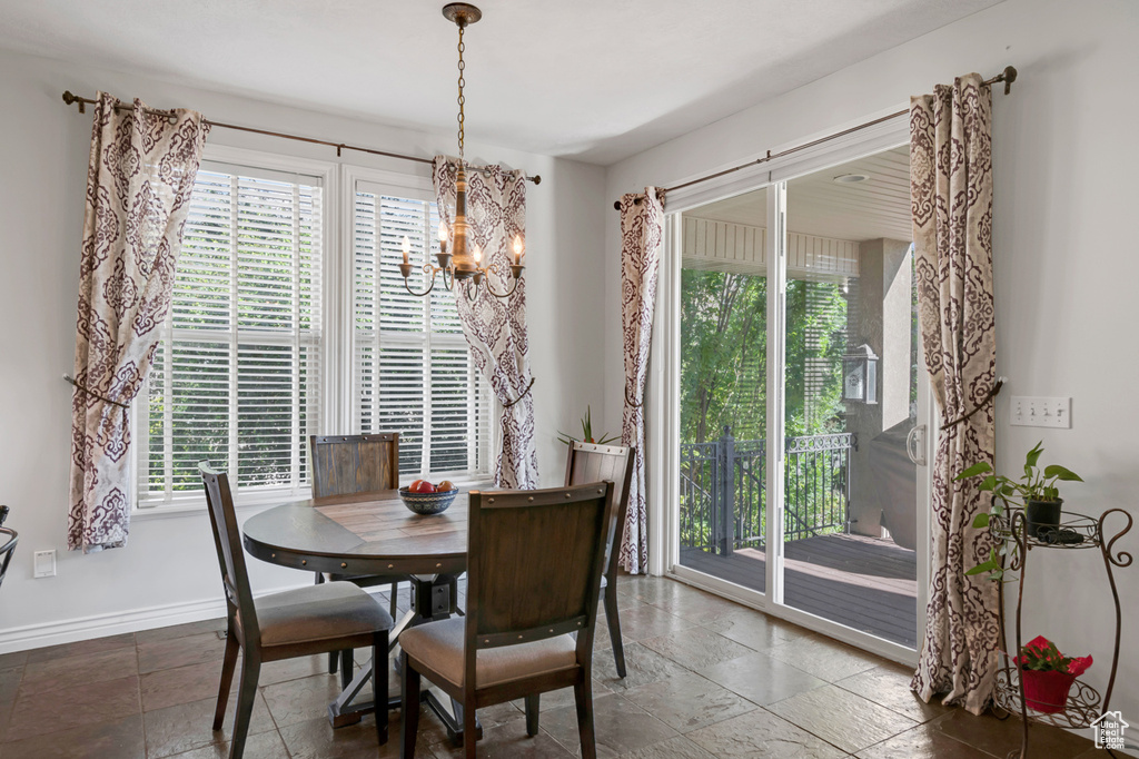 Tiled dining room with a notable chandelier