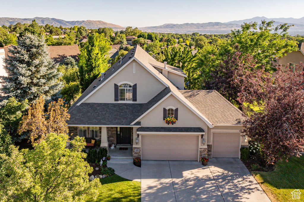 View of front of property with a mountain view and a garage