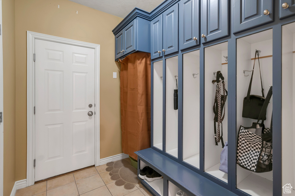 Mudroom with light tile patterned flooring