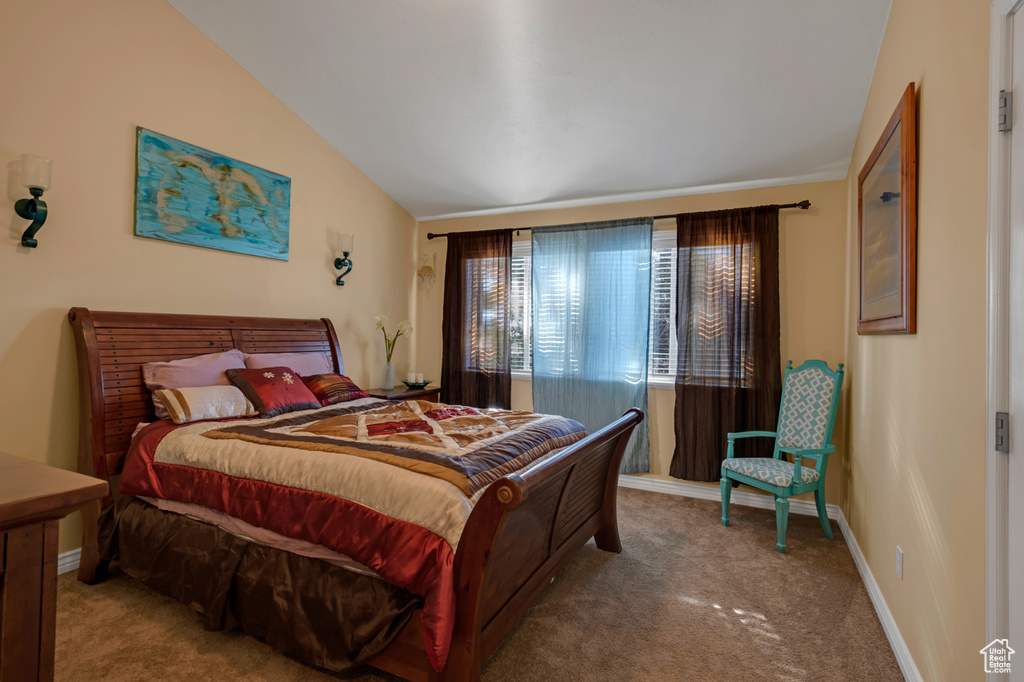 Bedroom featuring carpet flooring and vaulted ceiling