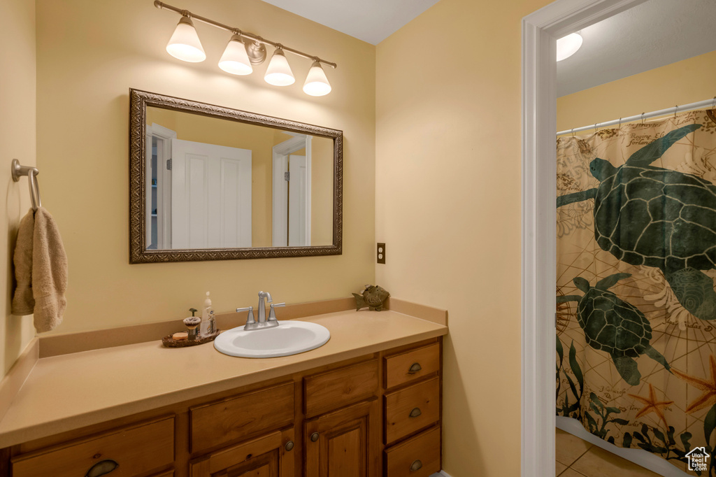 Bathroom with tile patterned flooring and vanity