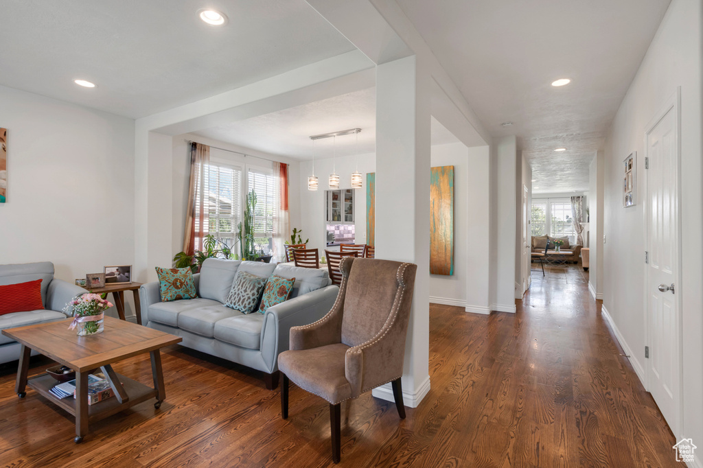 Living room featuring dark hardwood / wood-style floors and a wealth of natural light