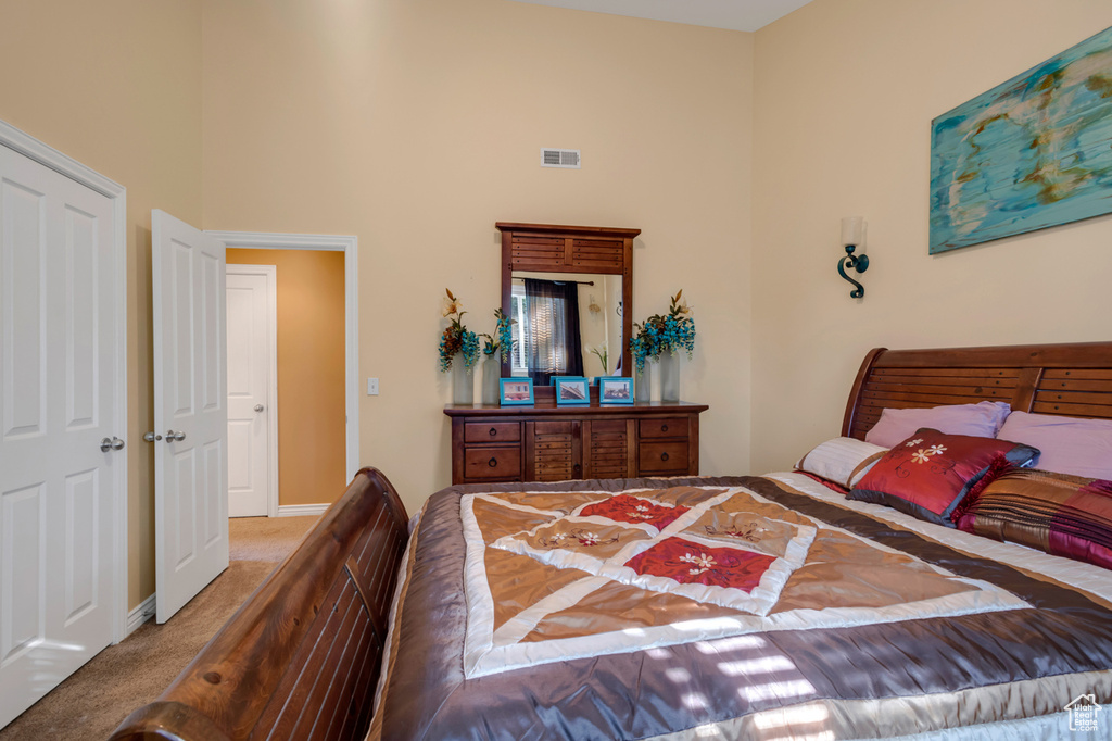 Bedroom with carpet flooring and a high ceiling