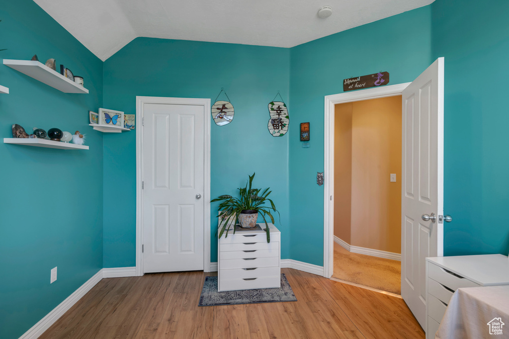 Misc room with lofted ceiling and wood-type flooring