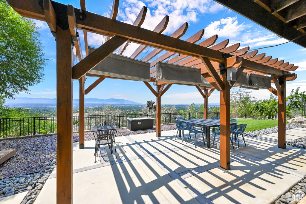 View of patio / terrace featuring a pergola and a mountain view