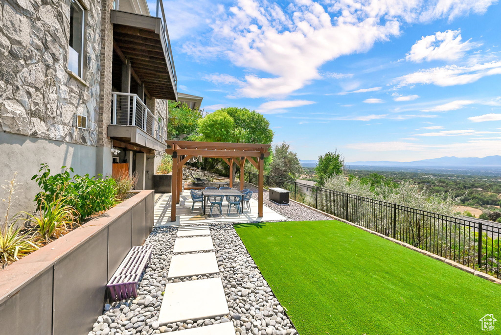 View of yard featuring a mountain view and a patio