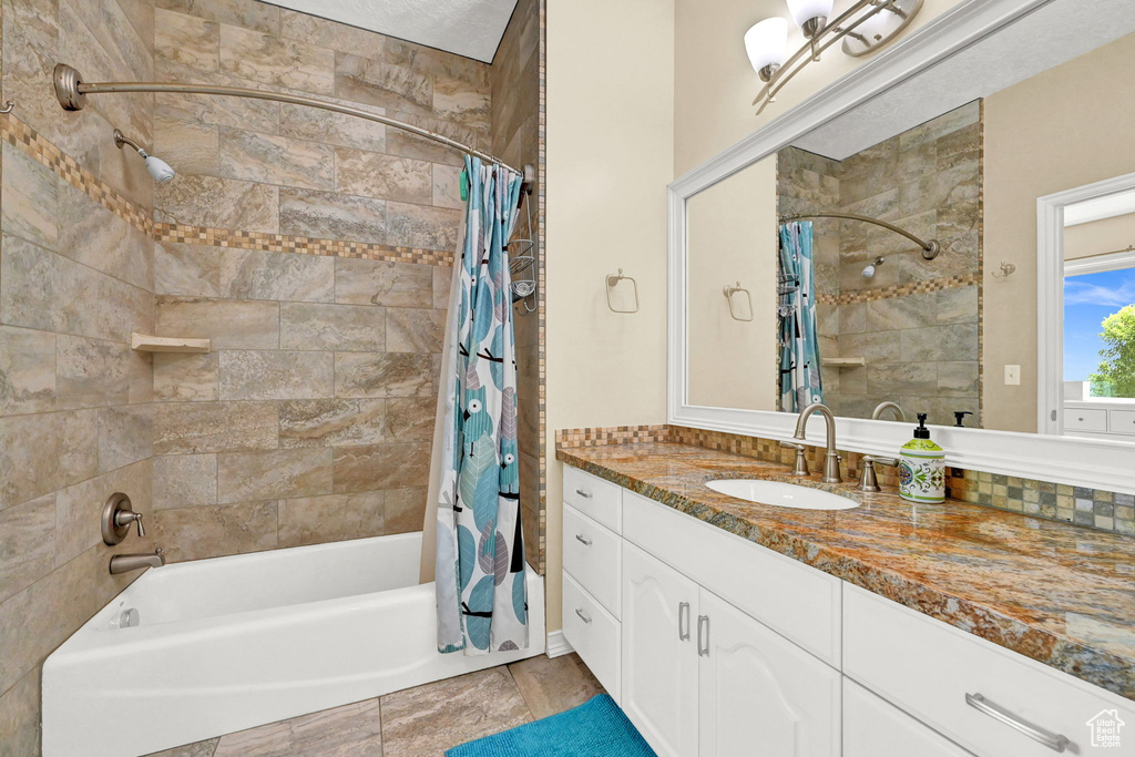 Bathroom with vanity, tile patterned flooring, and shower / bath combo