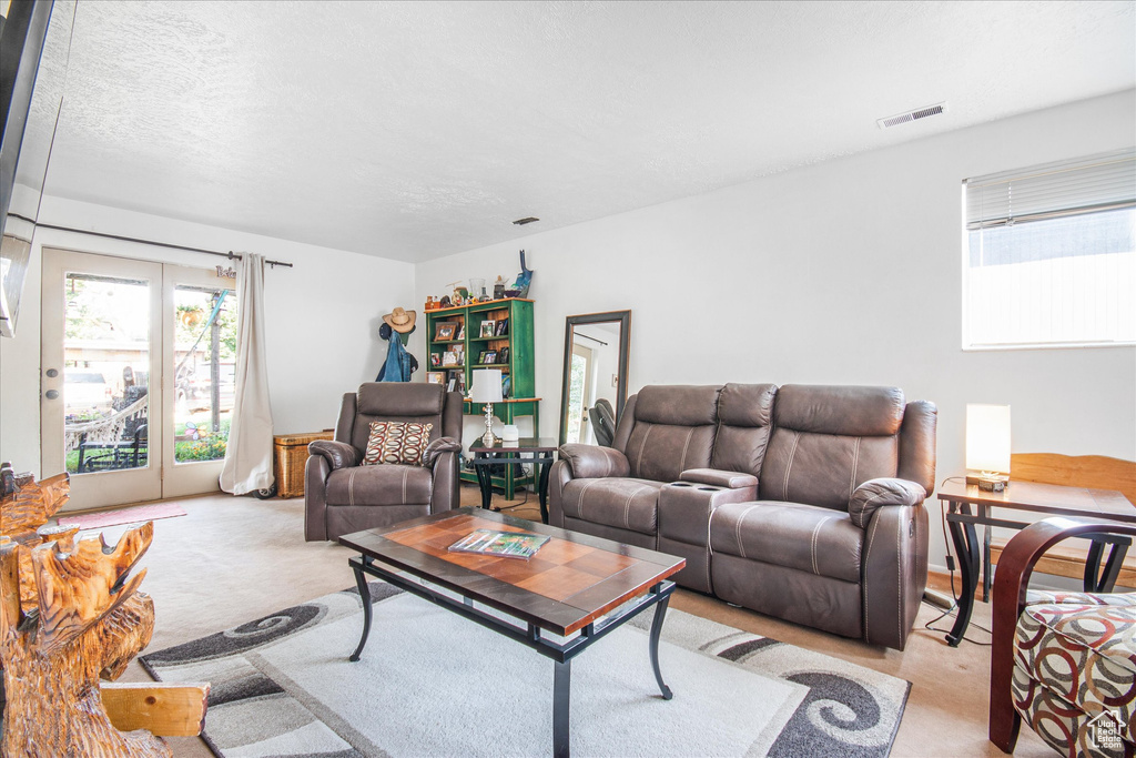 Living room featuring light carpet and french doors