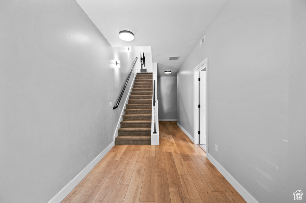 Staircase with light wood-type flooring