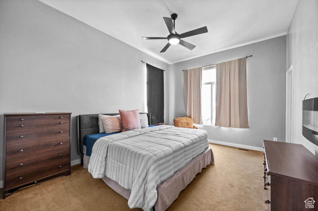 Bedroom featuring light colored carpet and ceiling fan