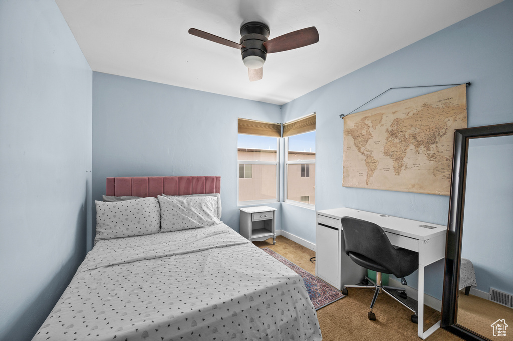 Bedroom featuring light colored carpet and ceiling fan