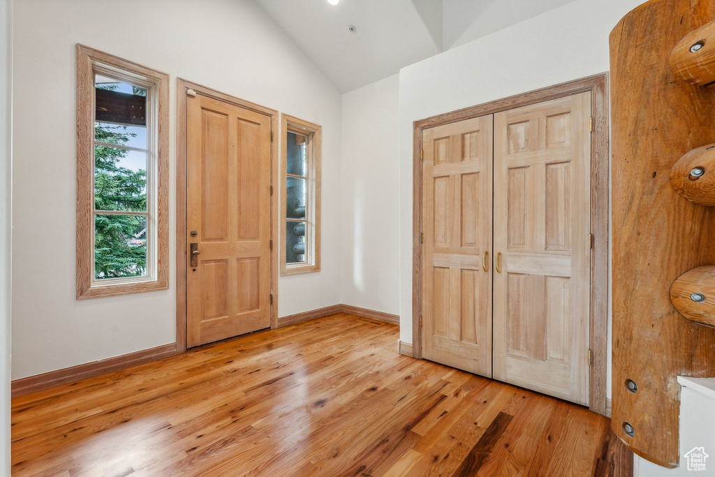 Foyer featuring light hardwood / wood-style floors and vaulted ceiling