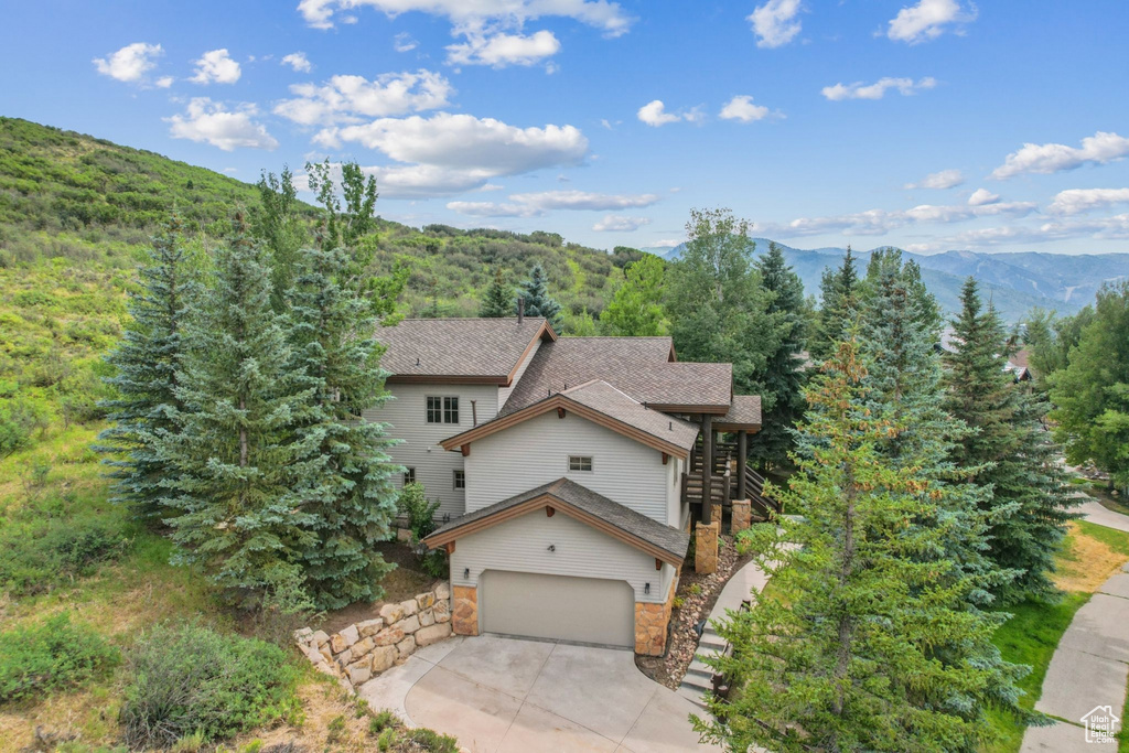 View of front of house featuring a mountain view and a garage