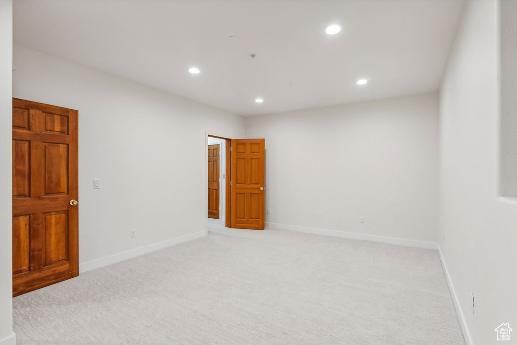 Empty room with light colored carpet