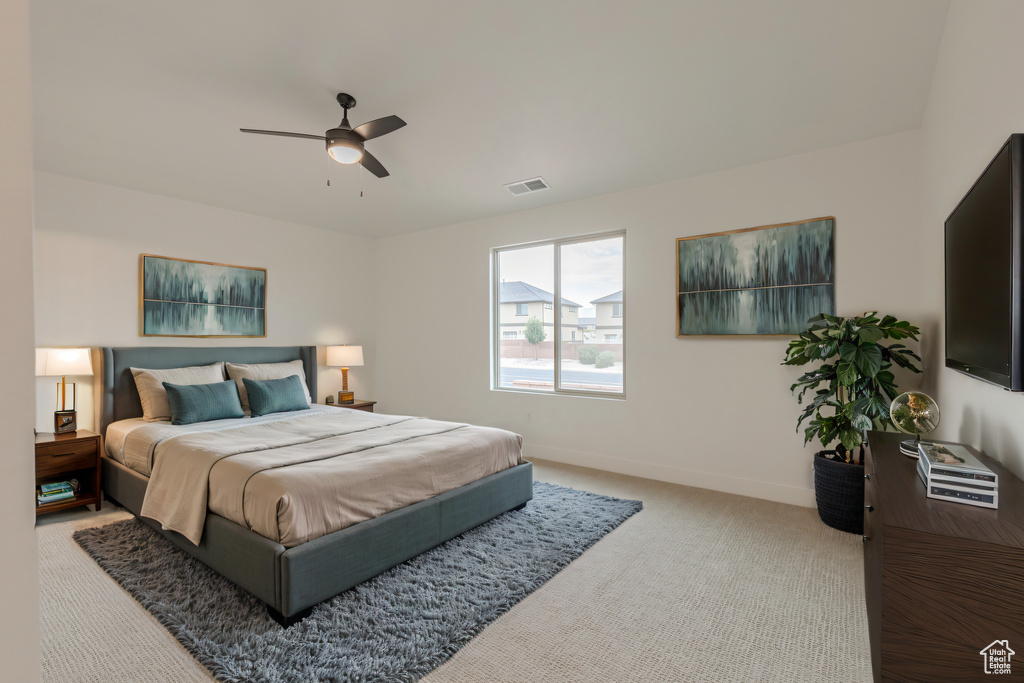 Bedroom featuring light carpet and ceiling fan