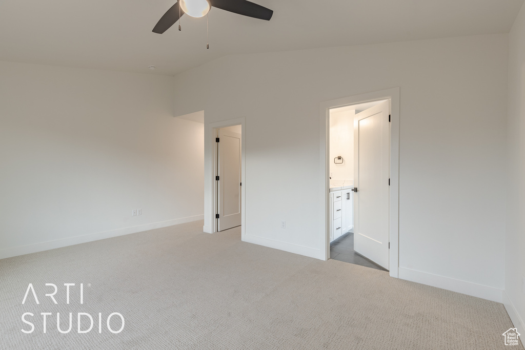 Unfurnished bedroom featuring light carpet, ceiling fan, and lofted ceiling