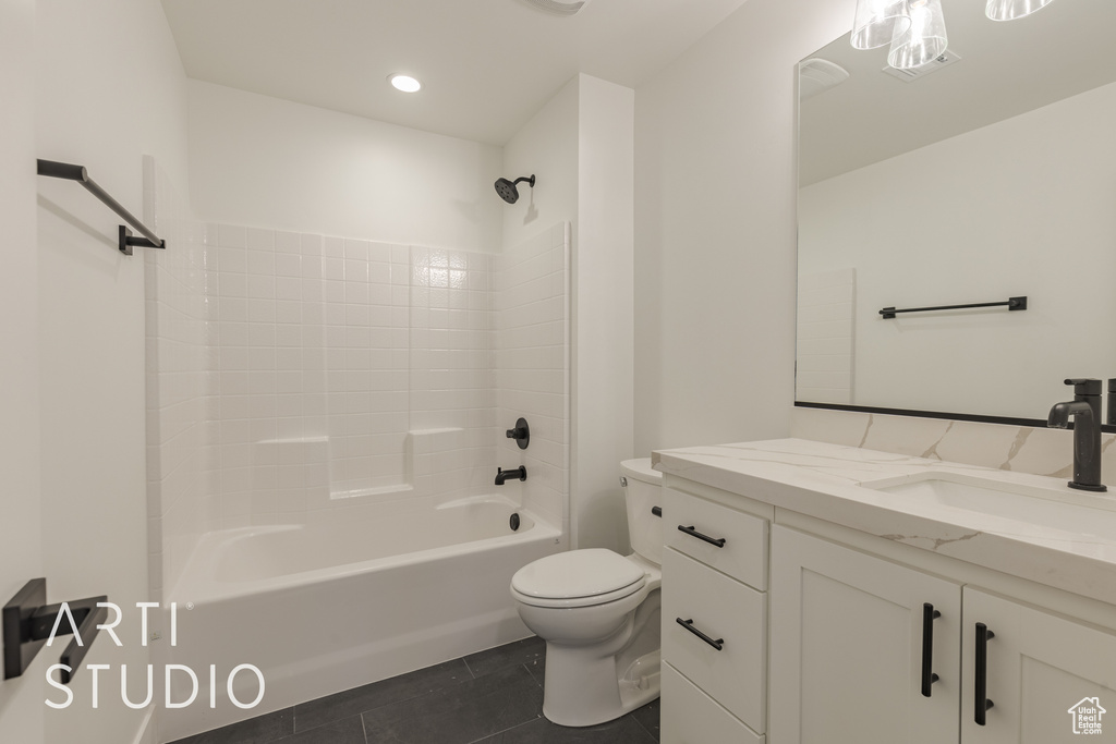 Full bathroom featuring vanity, shower / bath combination, tile patterned flooring, and toilet