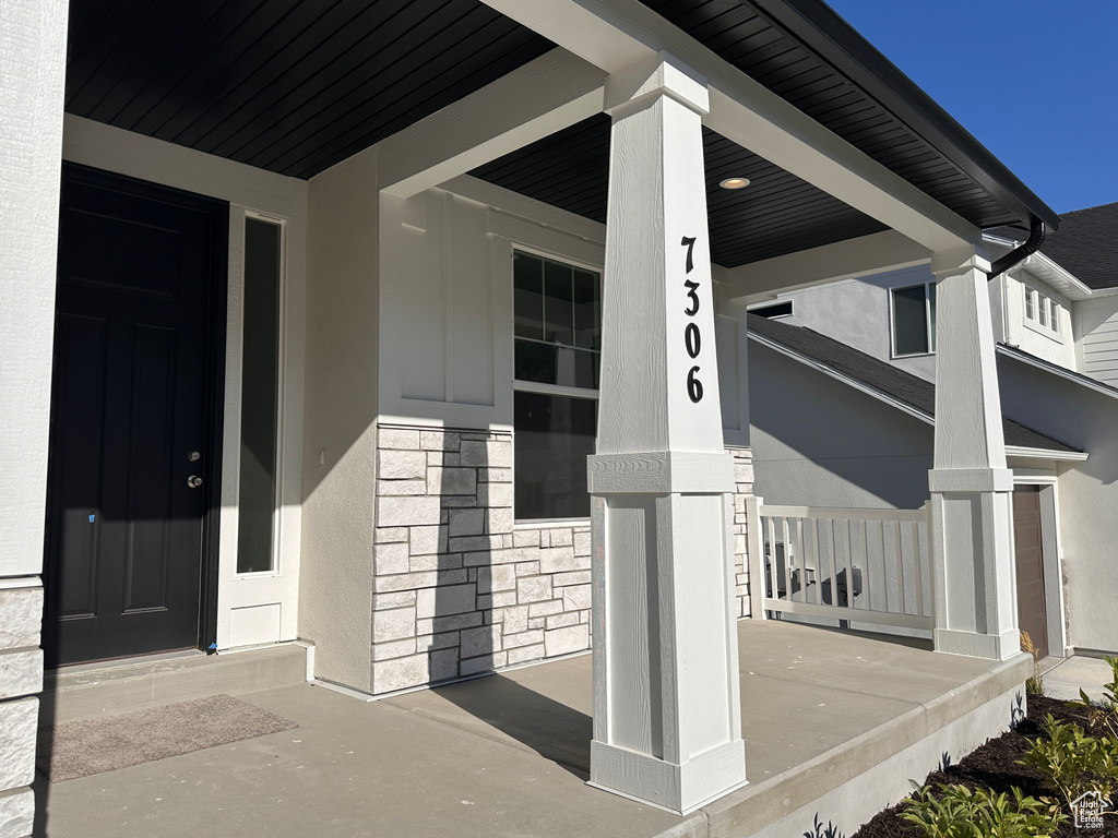 Doorway to property with covered porch