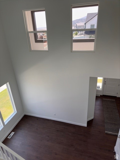 Empty room with dark hardwood / wood-style floors