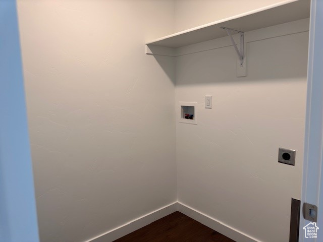 Laundry room featuring electric dryer hookup, hardwood / wood-style floors, and washer hookup