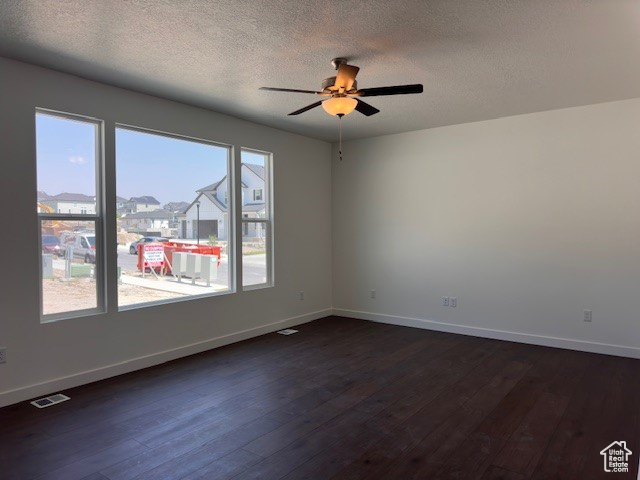 Unfurnished room with wood-type flooring, a textured ceiling, and ceiling fan