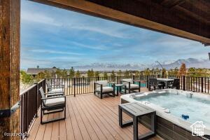 Wooden deck featuring a hot tub