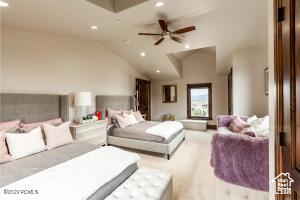 Bedroom with lofted ceiling and ceiling fan